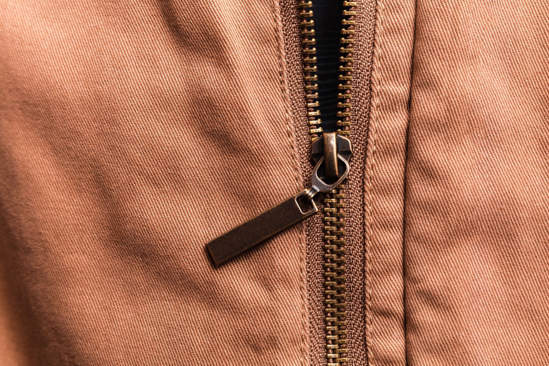 Close up of brown jeans zipper